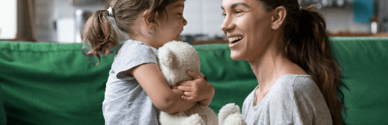 Child clutching a teddy bear and looking at an adult woman